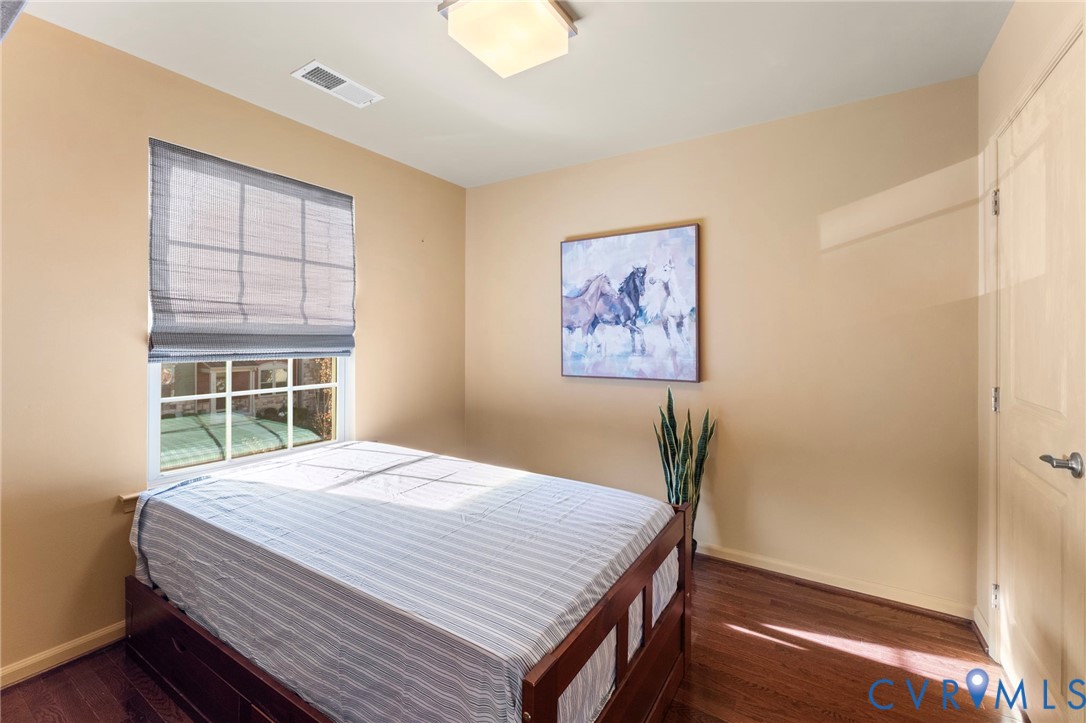 5504 Riverside Heights Way Richmond, VA 23225 - Photo 21 of 29 a bed sitting in a bedroom next to a window