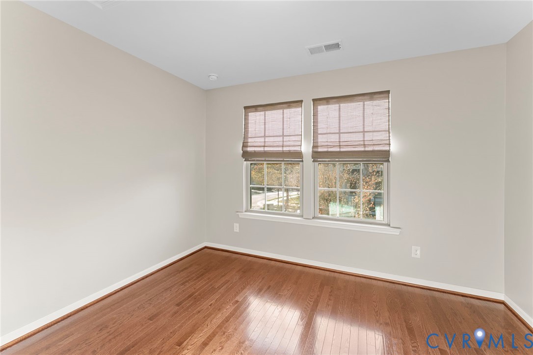 5504 Riverside Heights Way Richmond, VA 23225 - Photo 23 of 29 an empty room with wooden floor and windows