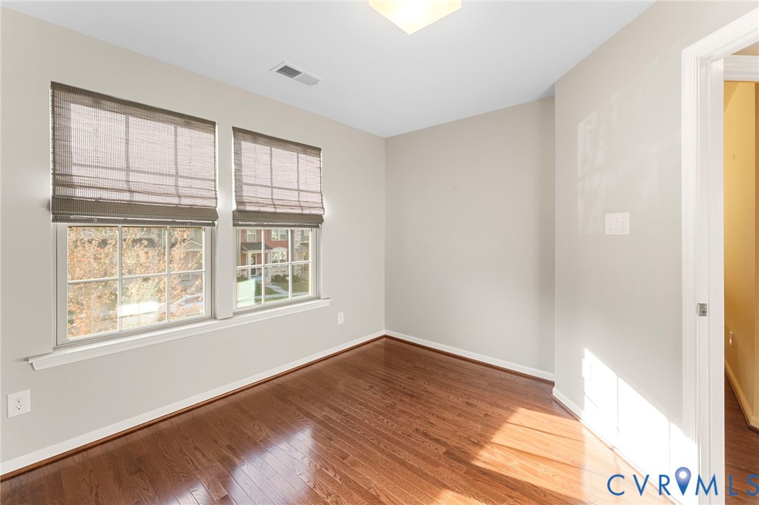 5504 Riverside Heights Way Richmond, VA 23225 - Photo 24 of 29 a view of an empty room with wooden floor and a window