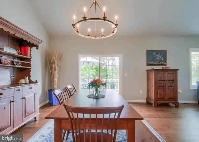 a dining room with furniture a chandelier and window