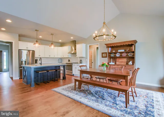 a living room with furniture a dining table and kitchen view