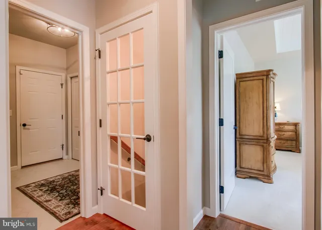 a view of a utility room with cabinet and mirrors