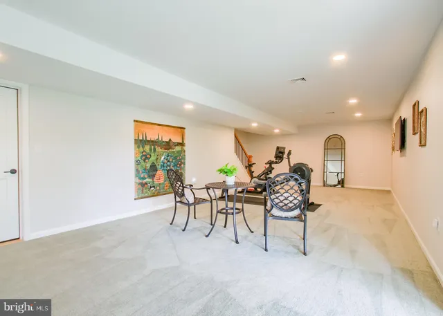 a dining room with furniture and a window