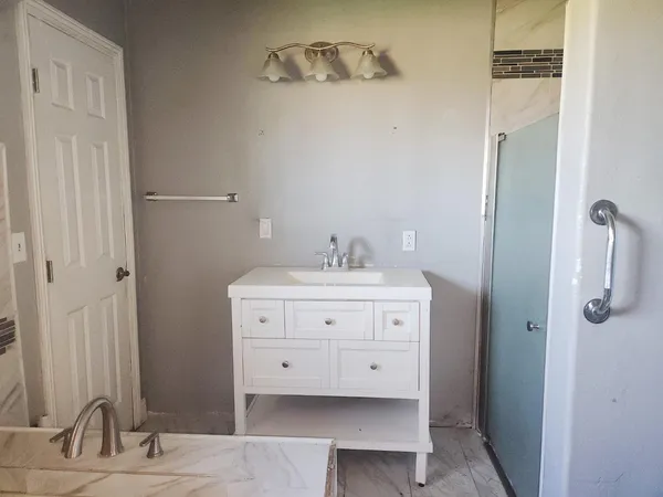 a bathroom with a sink double vanity and a mirror
