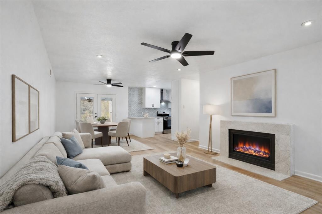 525 West Ridgewood Drive Garland, TX 75041 - Photo 3 of 39 Virtual Staged Living Room & Dining Area with Virtual Electric Fireplace