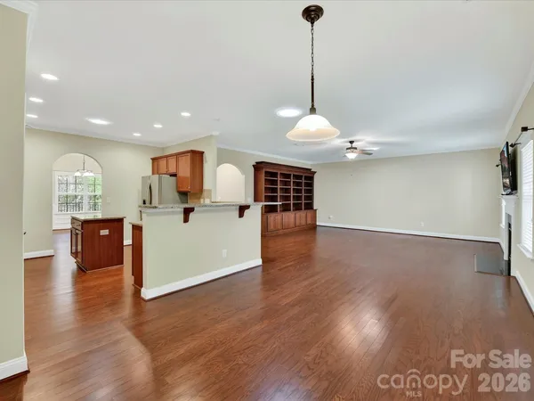 a view of a kitchen with a sink stainless steel appliances and a floor to ceiling window