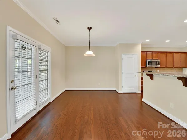 a view of a kitchen with a sink wooden floor and a large window
