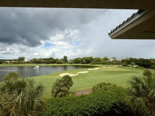 a view of a lake in between two chairs