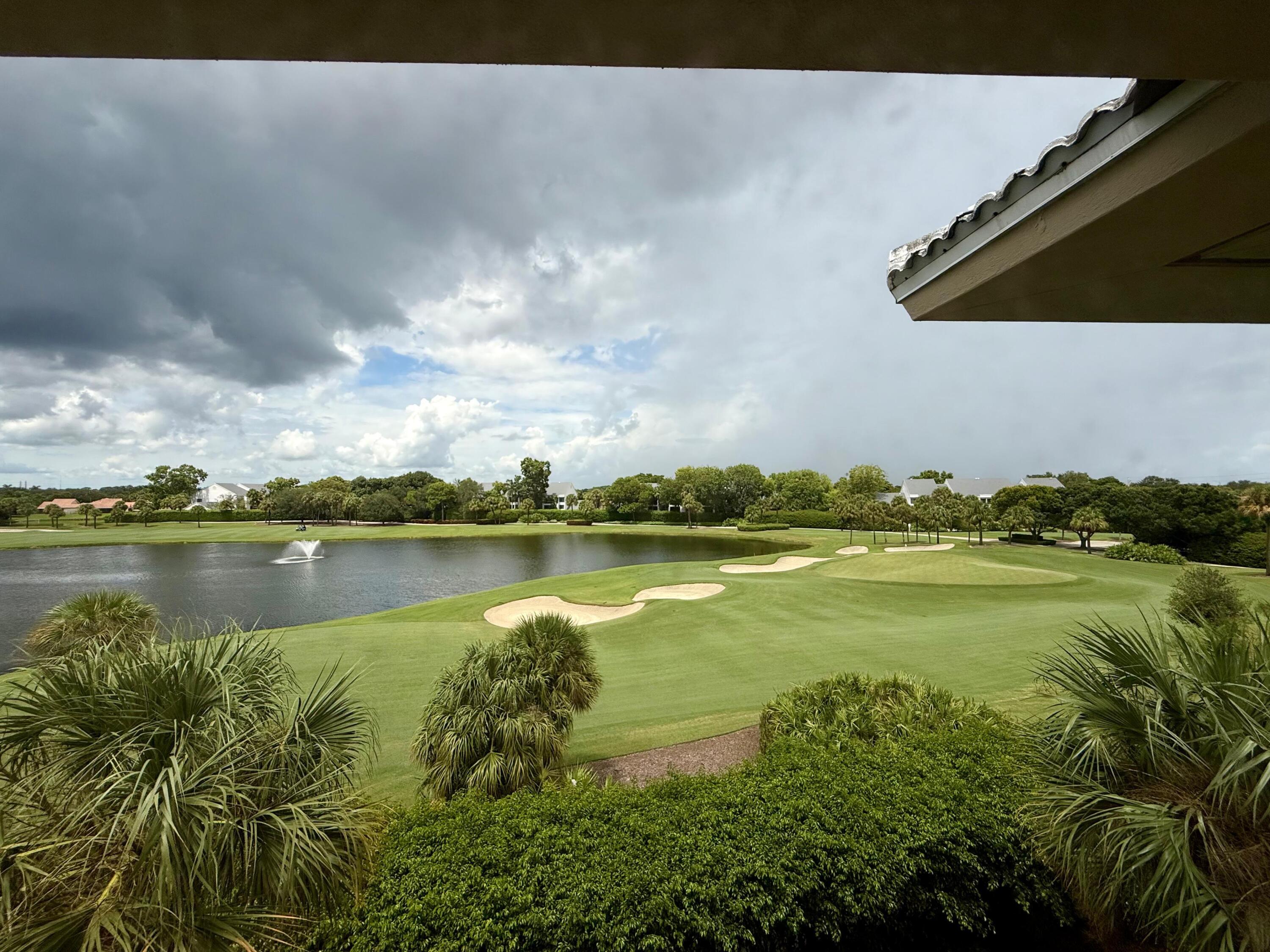 3525 Village Boulevard, Unit 401 West Palm Beach, FL 33409 - Photo 1 of 23 a view of a lake in between two chairs
