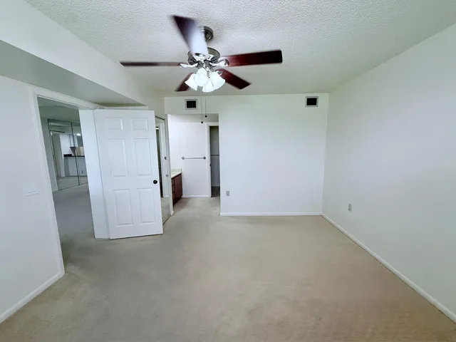 en empty room with closet and fan