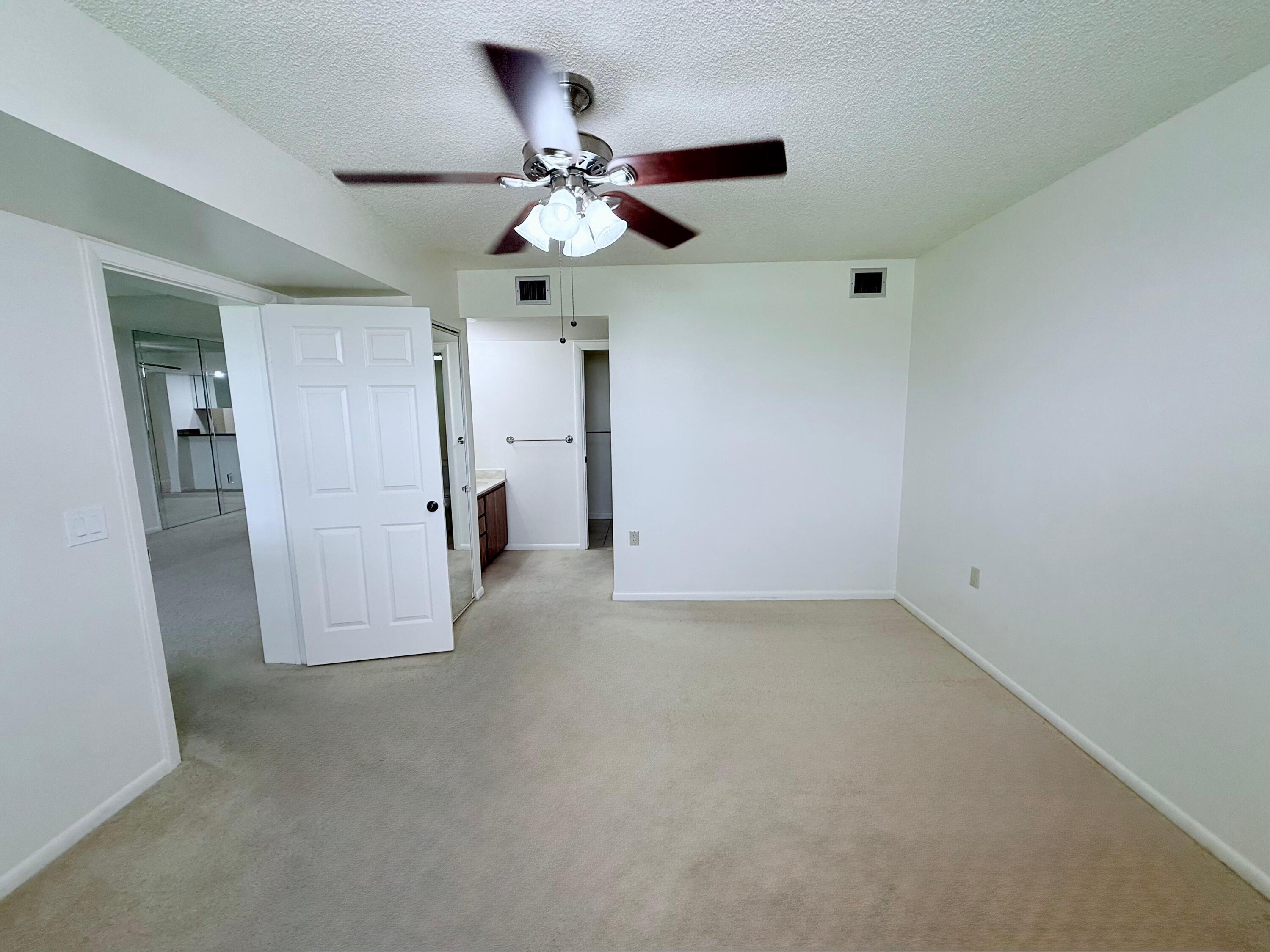 3525 Village Boulevard, Unit 401 West Palm Beach, FL 33409 - Photo 20 of 23 en empty room with closet and fan