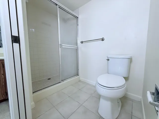 a bathroom with a toilet and a shower
