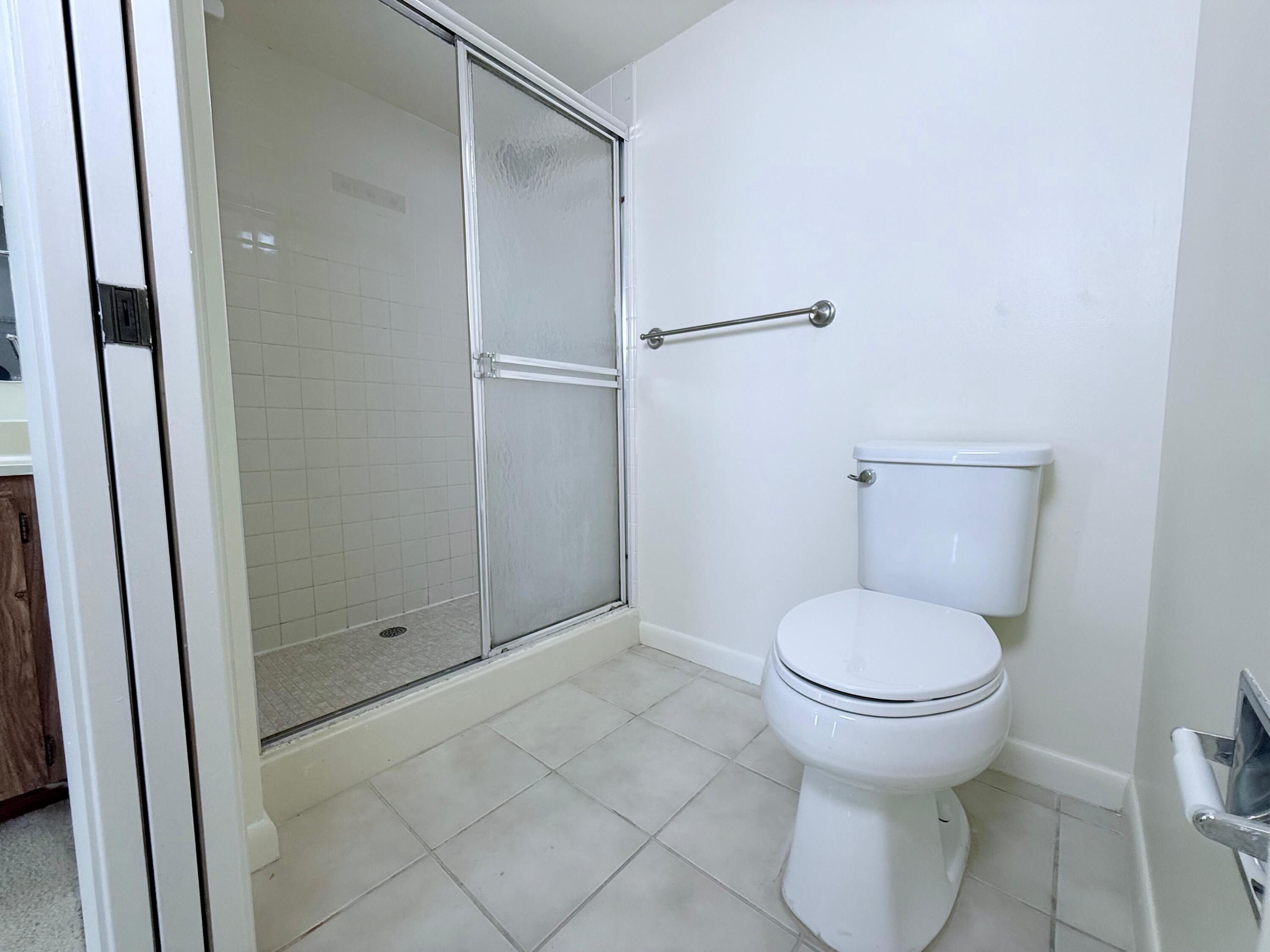 3525 Village Boulevard, Unit 401 West Palm Beach, FL 33409 - Photo 22 of 23 a bathroom with a toilet and a shower