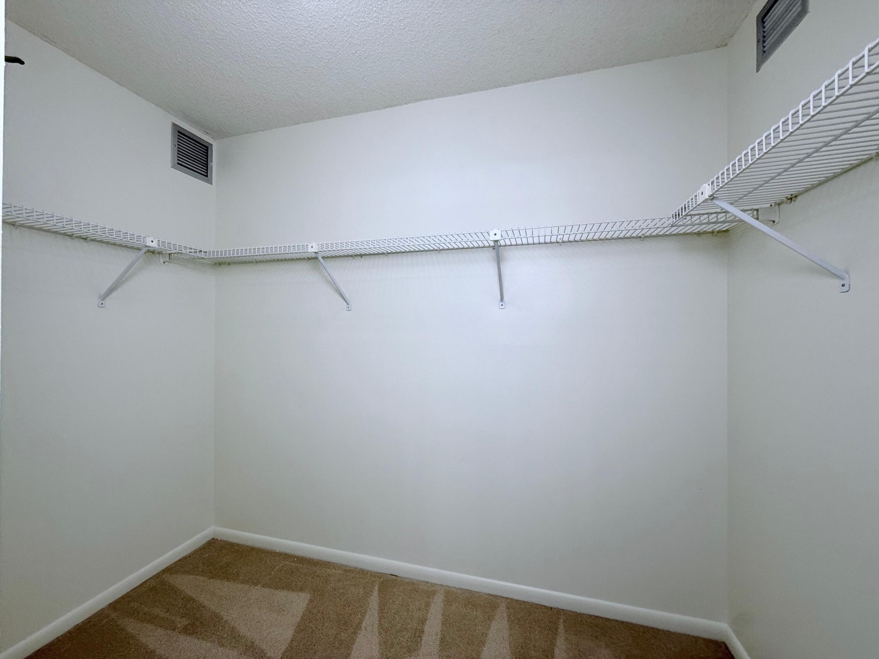 3525 Village Boulevard, Unit 401 West Palm Beach, FL 33409 - Photo 23 of 23 a view of a room with racks on the wall