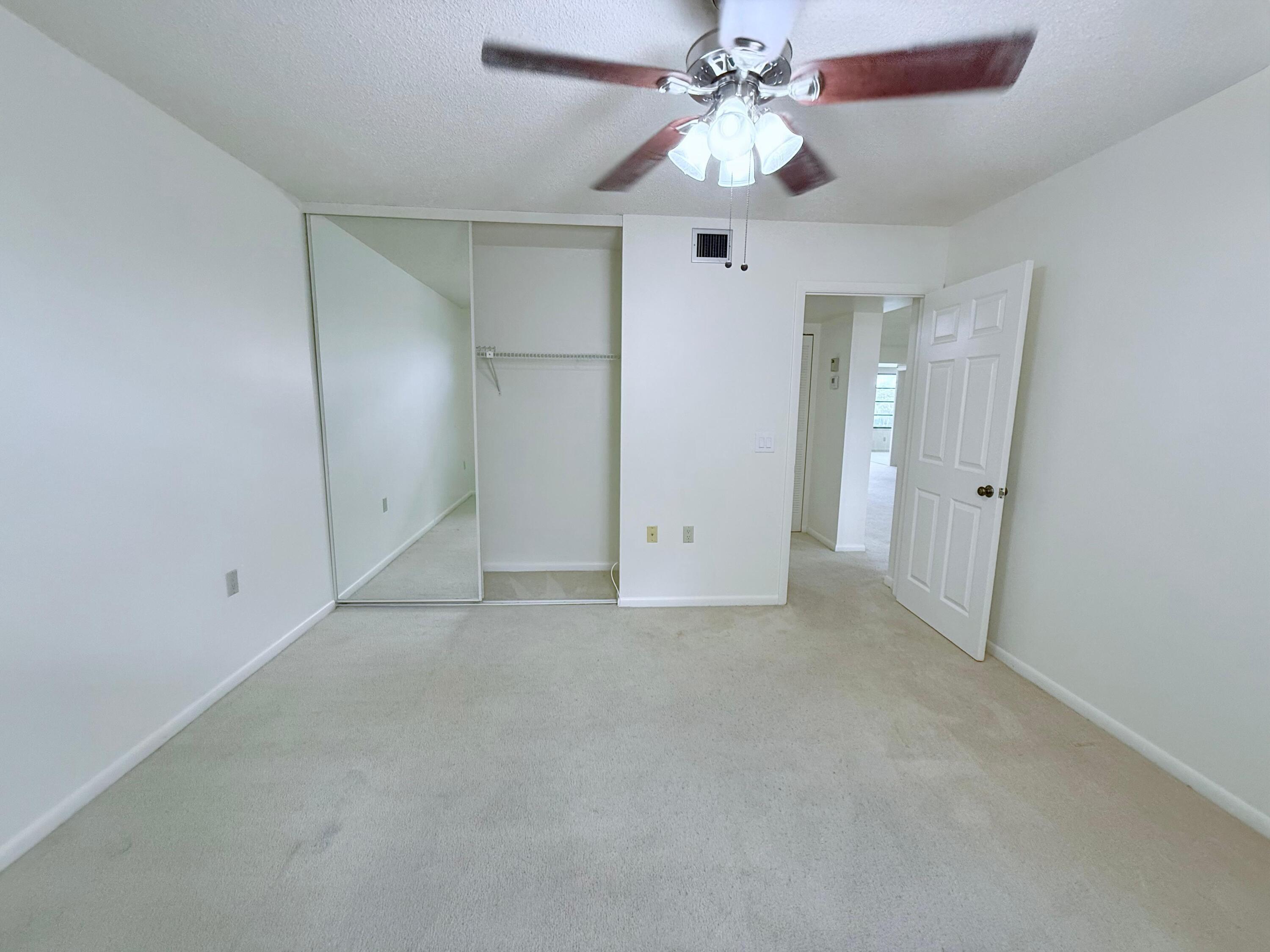 3525 Village Boulevard, Unit 401 West Palm Beach, FL 33409 - Photo 7 of 23 wooden floor in an empty room