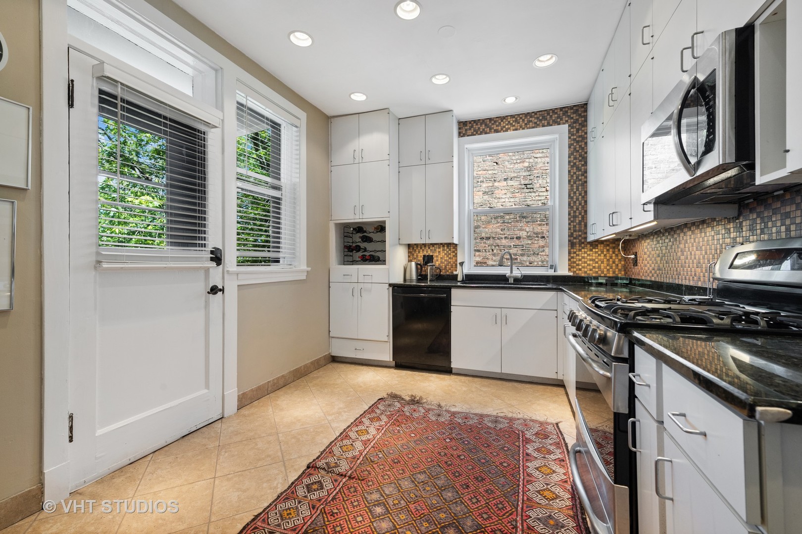 4506 North Beacon Street, Unit 3 Chicago, IL 60640 - Photo 21 of 23 a kitchen with stainless steel appliances granite countertop a stove a sink and a microwave