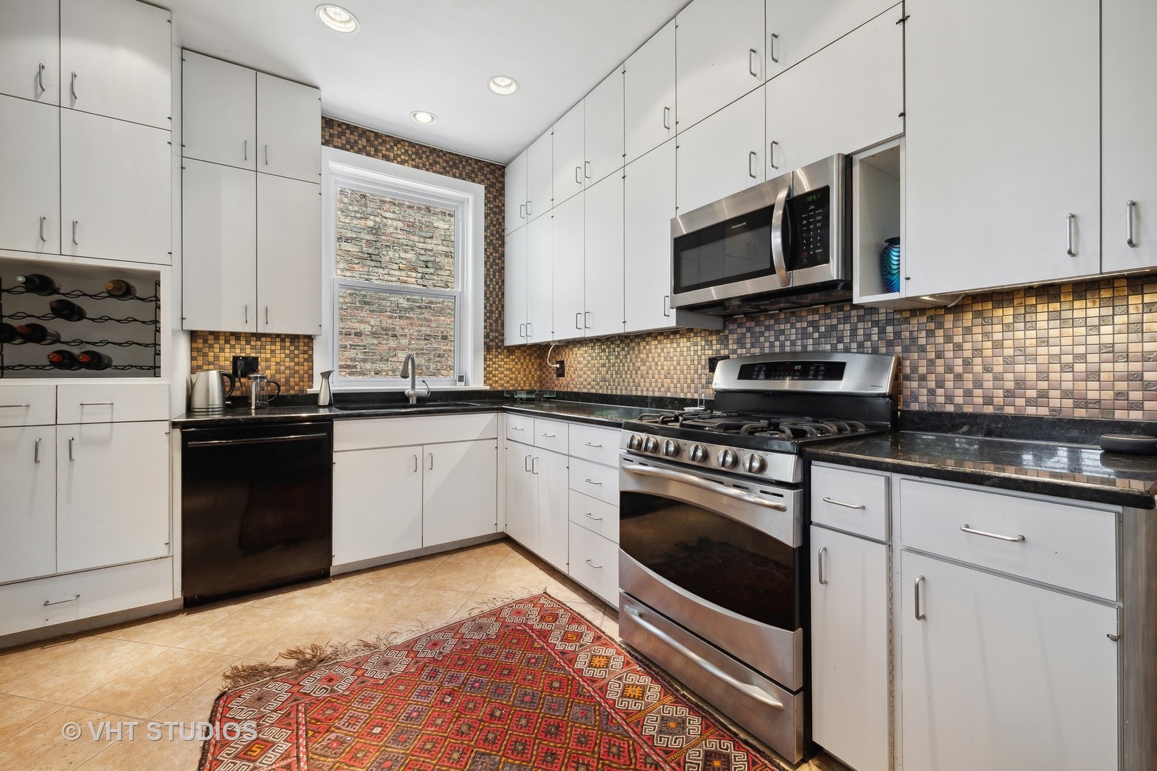 4506 North Beacon Street, Unit 3 Chicago, IL 60640 - Photo 22 of 23 a kitchen with stainless steel appliances granite countertop a stove a sink and a microwave