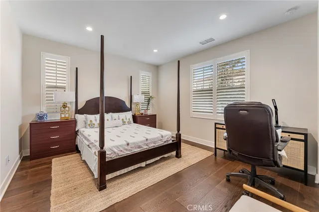 a bedroom with a bed a desk and chair