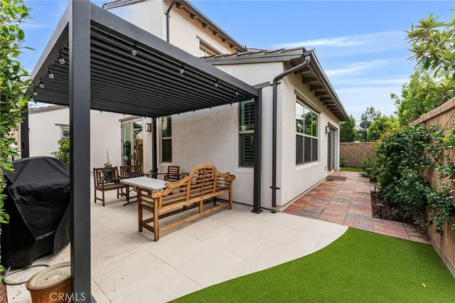 a view of a patio with table and chairs potted plants