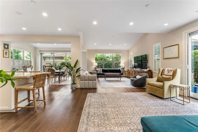a living room with fireplace furniture and wooden floor