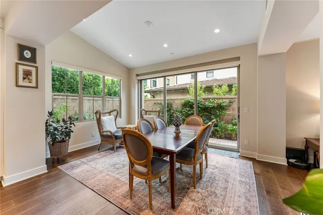 a dining room with furniture and a floor to ceiling window