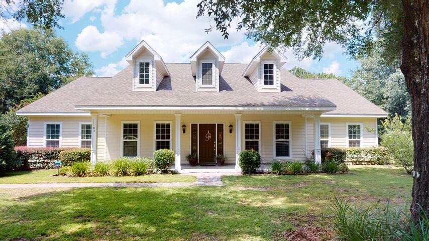 83 Launch Road DeFuniak Springs, FL 32433 - Photo 1 of 62 a front view of a house with a yard and porch