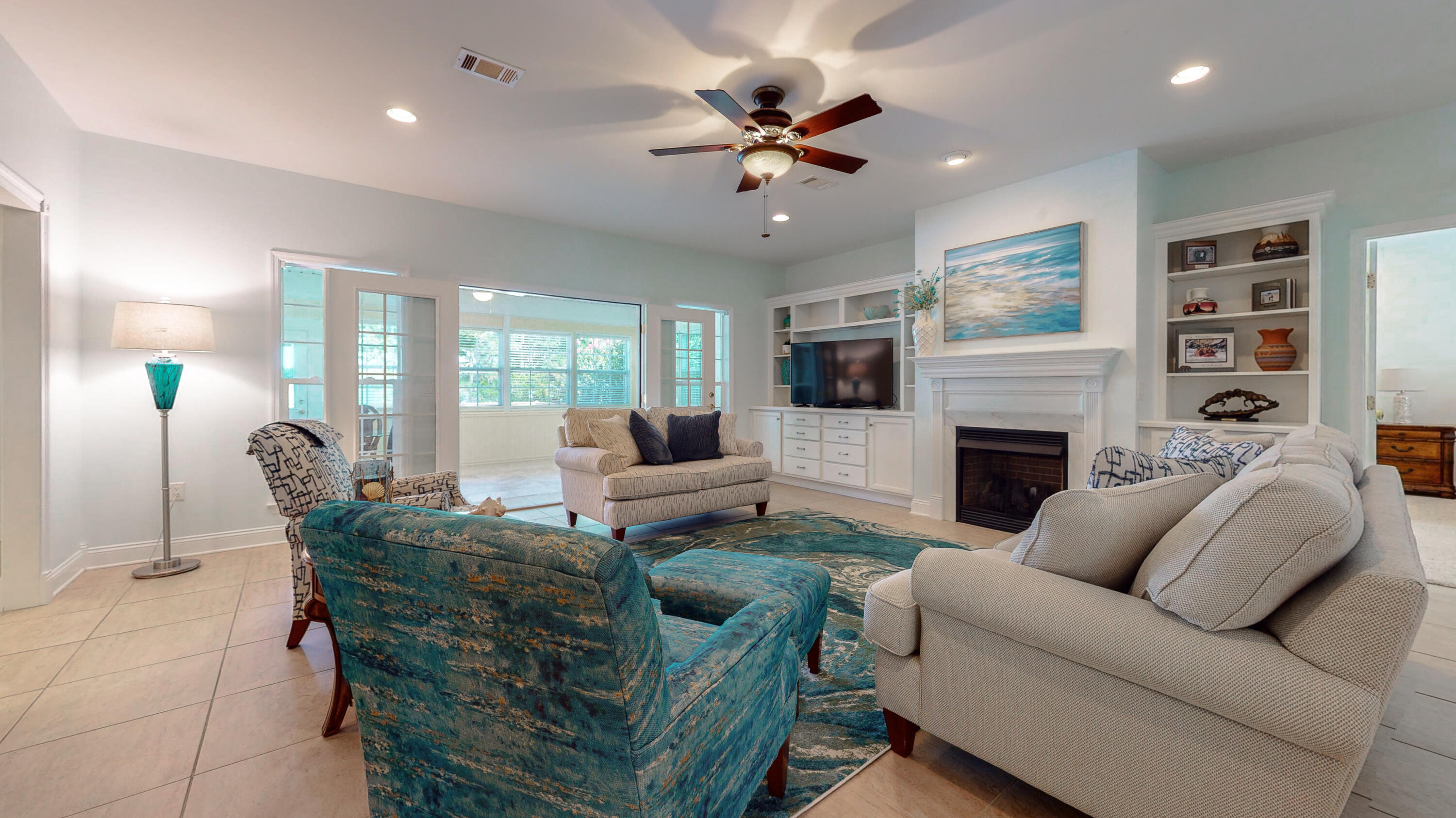 83 Launch Road DeFuniak Springs, FL 32433 - Photo 15 of 62 a living room with furniture a fireplace and a flat screen tv