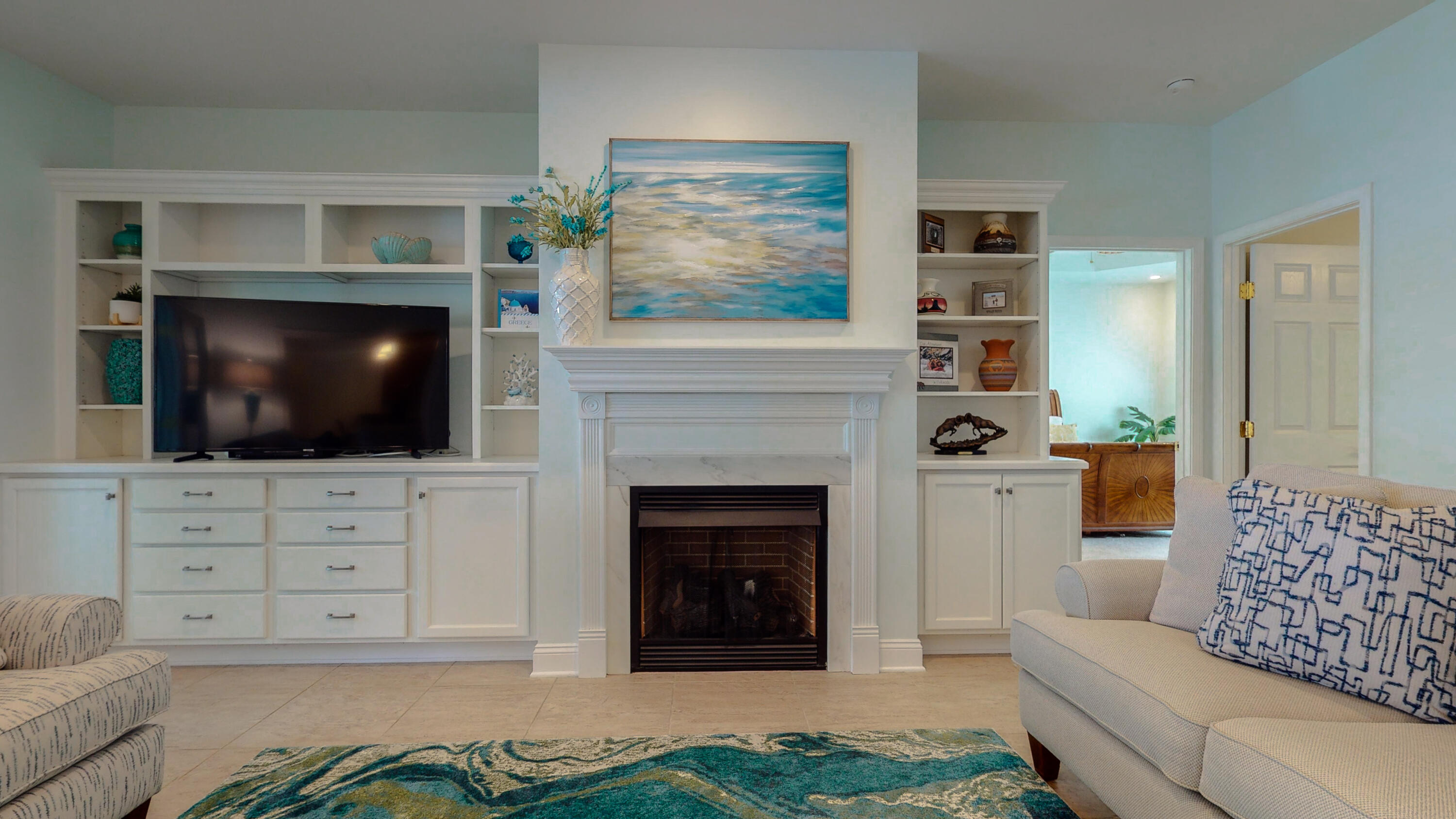 83 Launch Road DeFuniak Springs, FL 32433 - Photo 17 of 62 a living room with furniture a flat screen tv and a fireplace