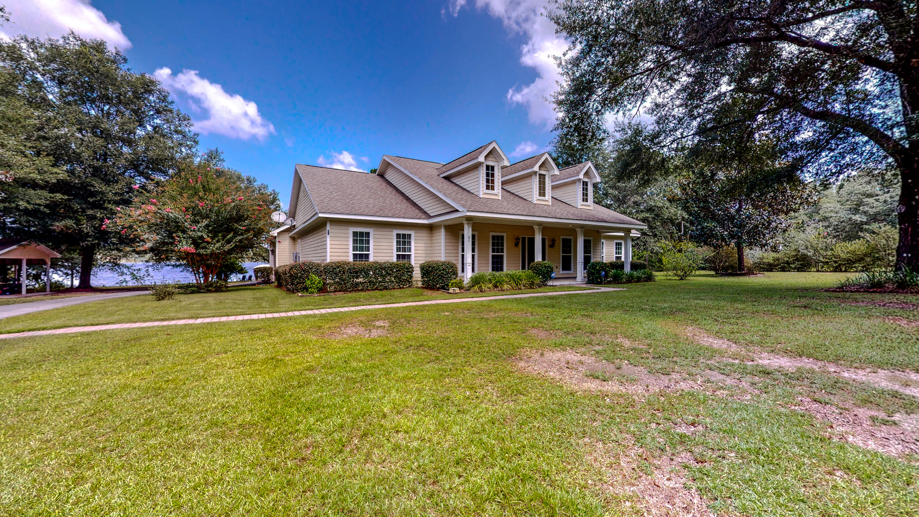 83 Launch Road DeFuniak Springs, FL 32433 - Photo 3 of 62 a front view of a house with swimming pool and yard