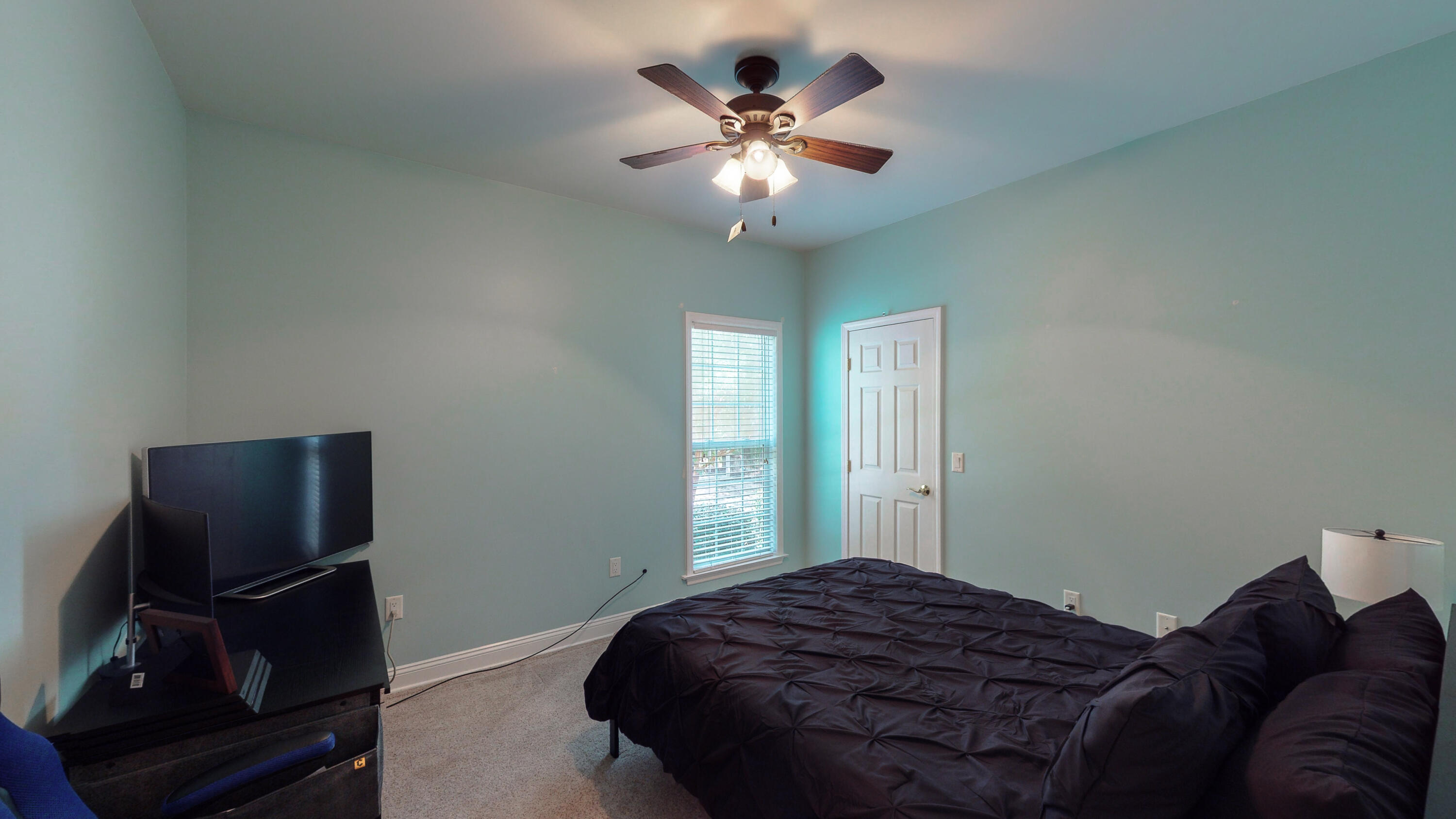 83 Launch Road DeFuniak Springs, FL 32433 - Photo 45 of 62 a bedroom with a bed and a chandelier
