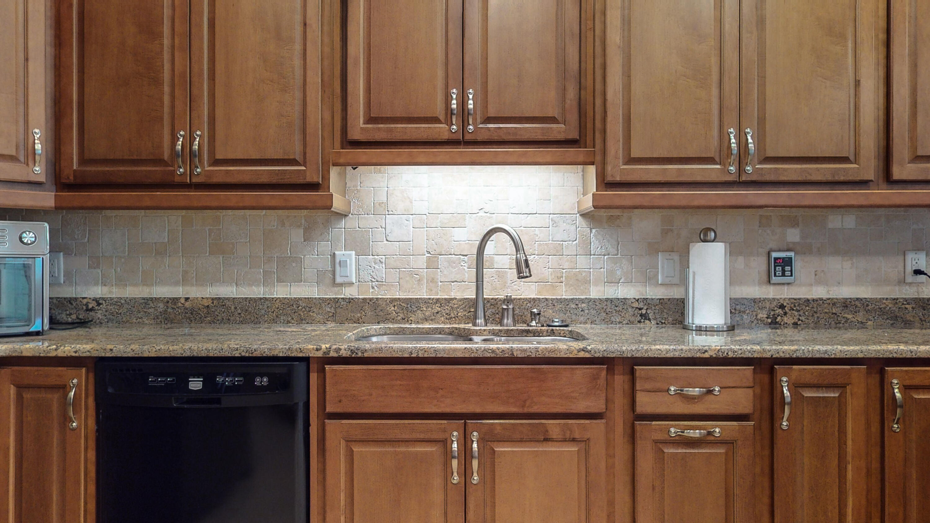 83 Launch Road DeFuniak Springs, FL 32433 - Photo 5 of 62 a kitchen with granite countertop stainless steel appliances granite countertop white cabinets sink and dishwasher