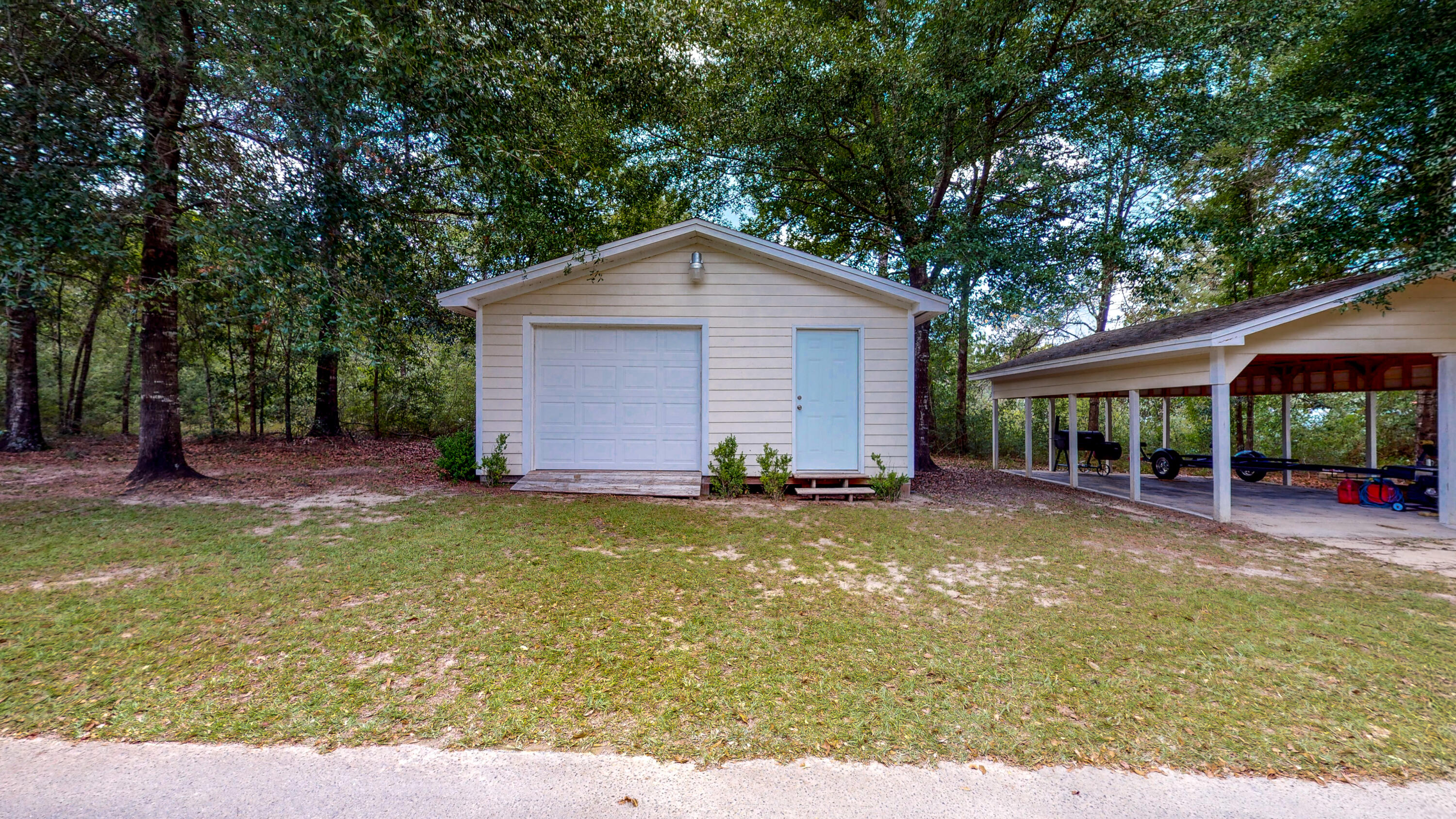 83 Launch Road DeFuniak Springs, FL 32433 - Photo 54 of 62 a view of a house with a yard and large tree