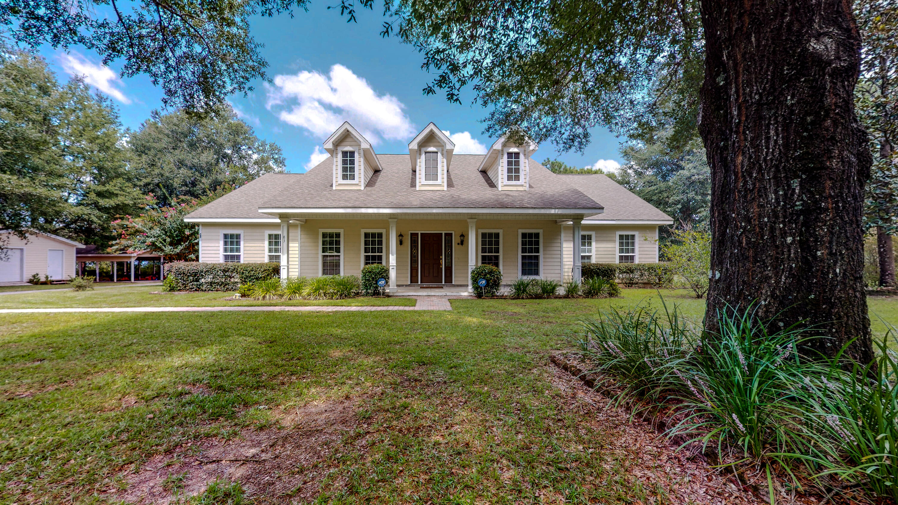 83 Launch Road DeFuniak Springs, FL 32433 - Photo 56 of 62 a front view of a house with a garden