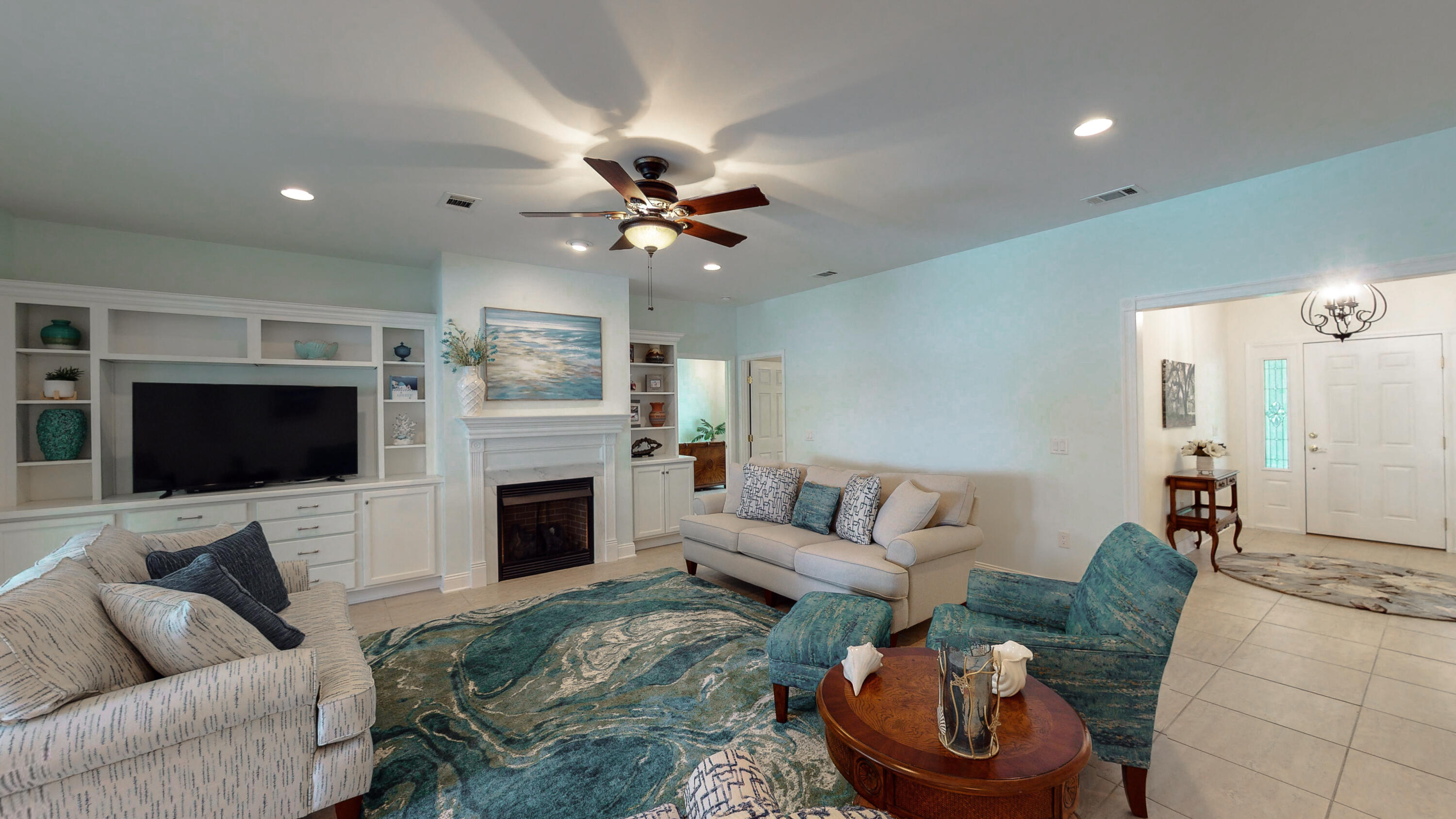 83 Launch Road DeFuniak Springs, FL 32433 - Photo 58 of 62 a living room with furniture a fireplace and a flat screen tv