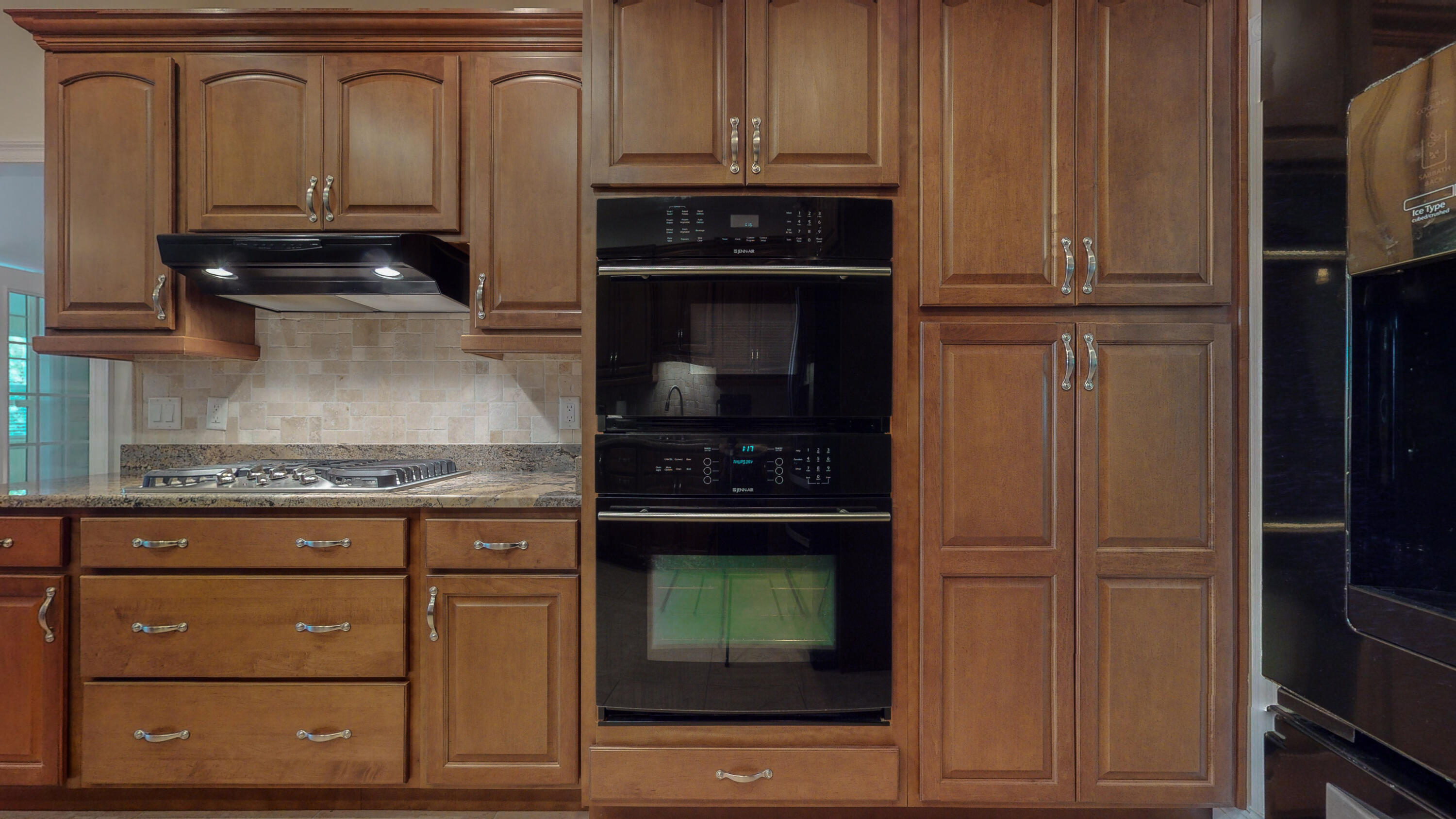 83 Launch Road DeFuniak Springs, FL 32433 - Photo 6 of 62 a kitchen with granite countertop wooden cabinets and a stove top oven