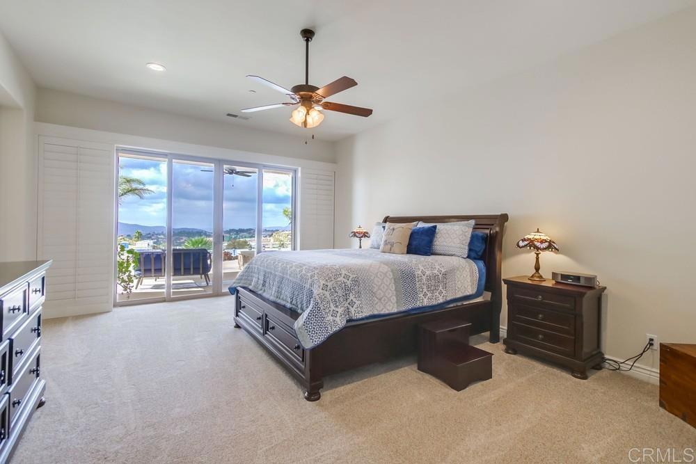 2893 Overland Passage Alpine, CA 91901 - Photo 21 of 51 a spacious bedroom with a bed a chandelier and a large window