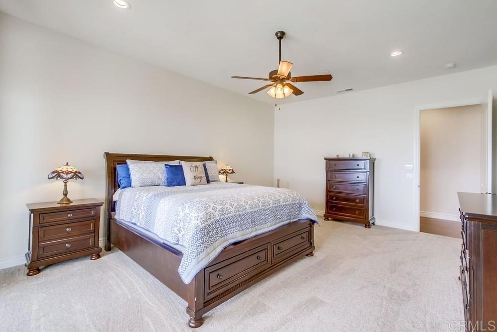 2893 Overland Passage Alpine, CA 91901 - Photo 23 of 51 a bedroom with a bed and a chandelier