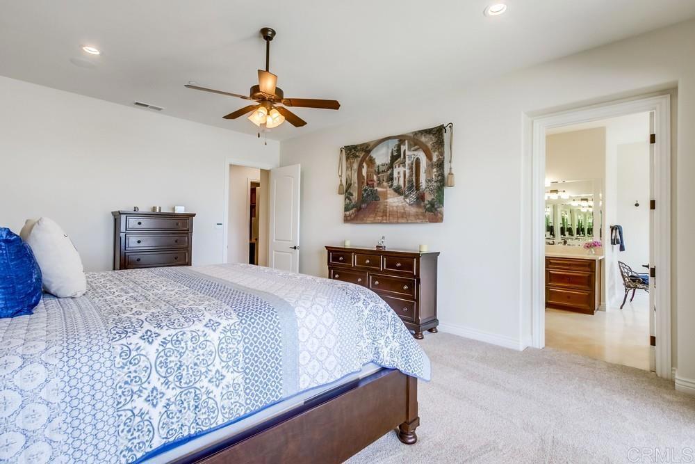 2893 Overland Passage Alpine, CA 91901 - Photo 24 of 51 a bedroom with a bed and a chandelier