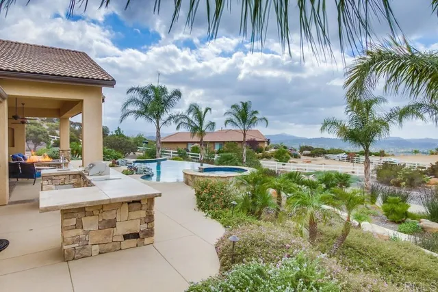 a view of swimming pool with outdoor seating and plants