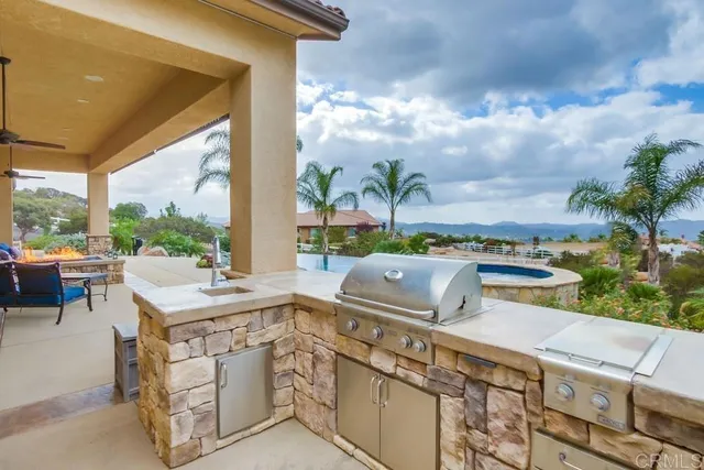 a view of a patio with a table and chairs