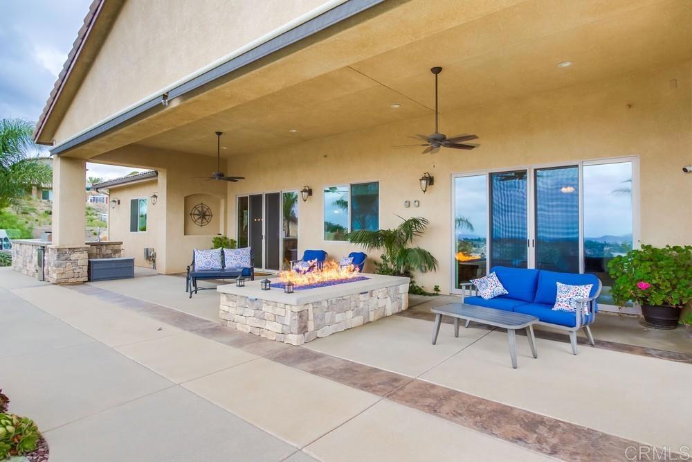 2893 Overland Passage Alpine, CA 91901 - Photo 47 of 51 a living room with patio furniture and a chandelier