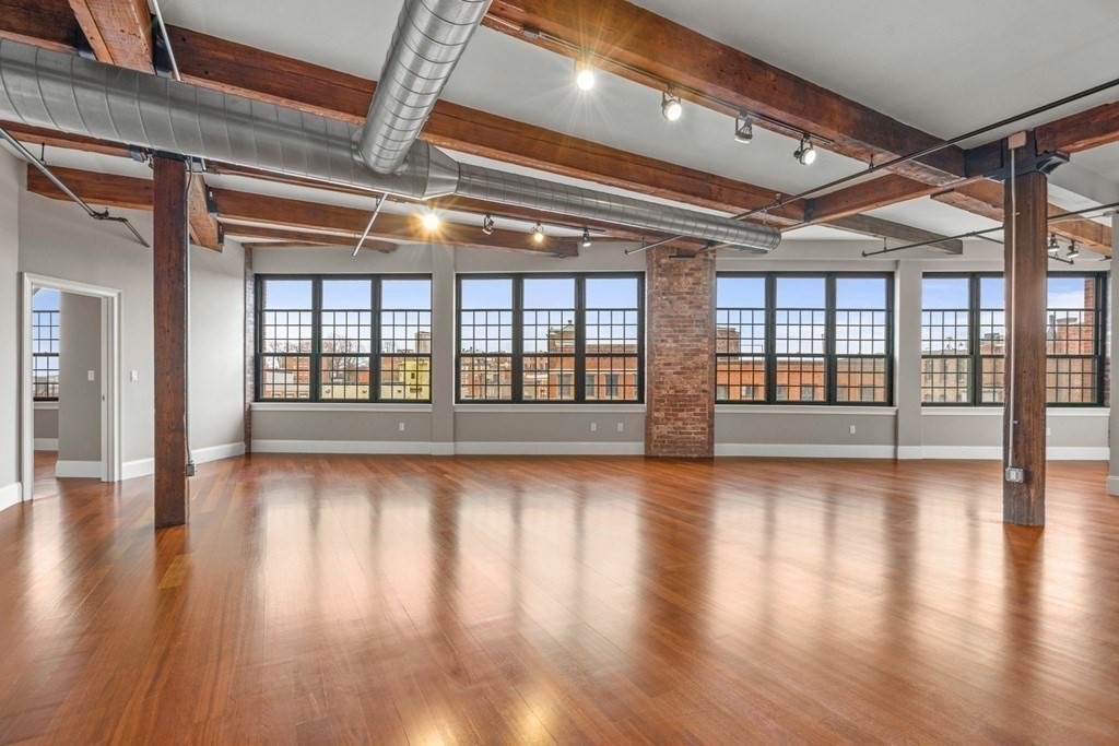 126 North Washington Street, Unit 3 Boston, MA 02114 - Photo 1 of 10 a view of an empty room with wooden floor and a window