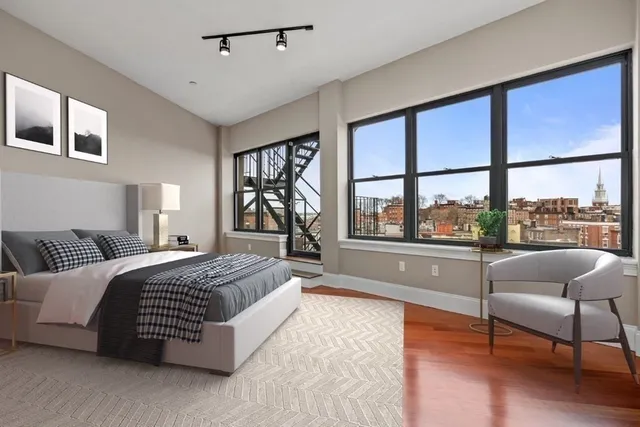 a spacious bedroom with a large bed and a large window