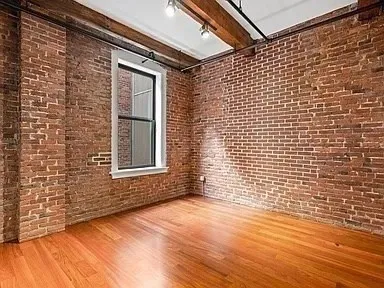 a view of an empty room and wooden floor