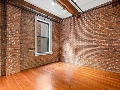 126 North Washington Street, Unit 3 Boston, MA 02114 - Photo 7 of 10 a view of an empty room and wooden floor