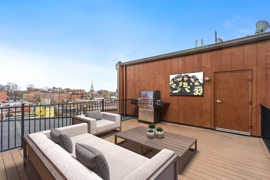 126 North Washington Street, Unit 3 Boston, MA 02114 - Photo 9 of 10 a view of a terrace with couches and wooden floor
