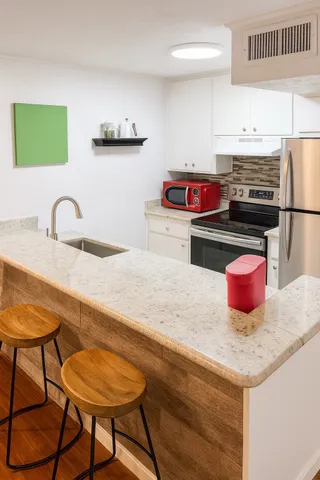 a kitchen with a sink cabinets and appliances