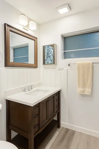 a bathroom with a sink vanity and a mirror