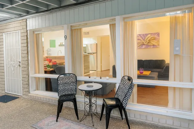 a dining room with furniture and a window