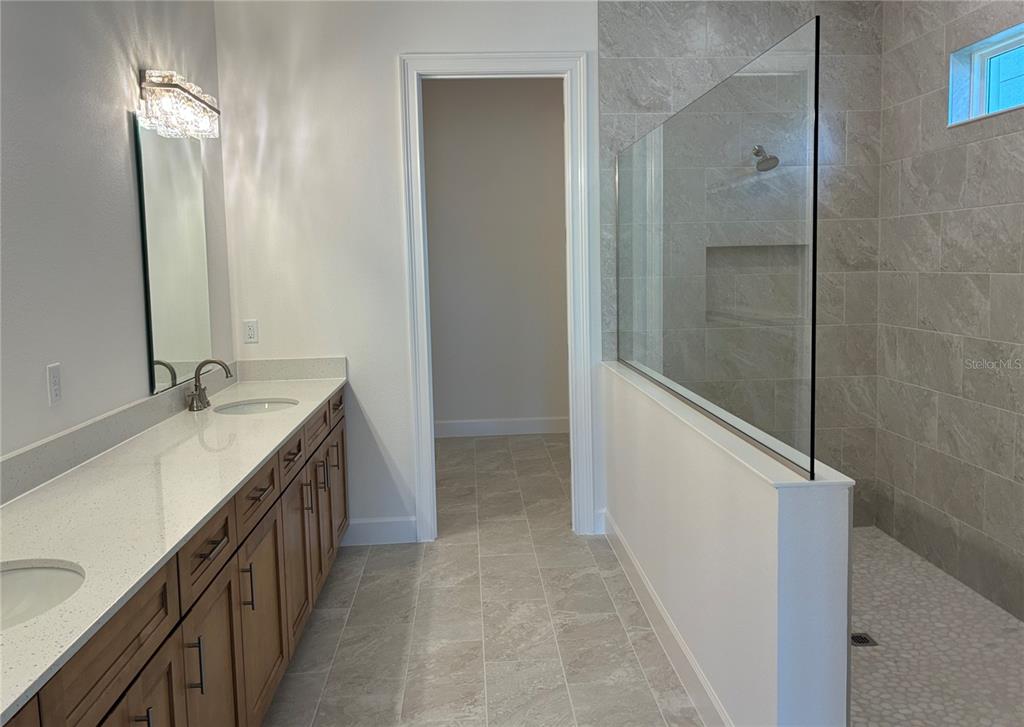 4 Coronado Road Flagler Beach, FL 32136 - Photo 27 of 30 a bathroom with a double vanity sink and mirror